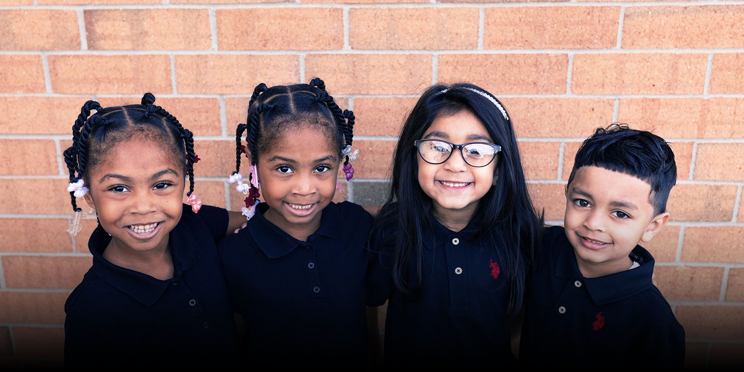 Smiling students with their arms around one another